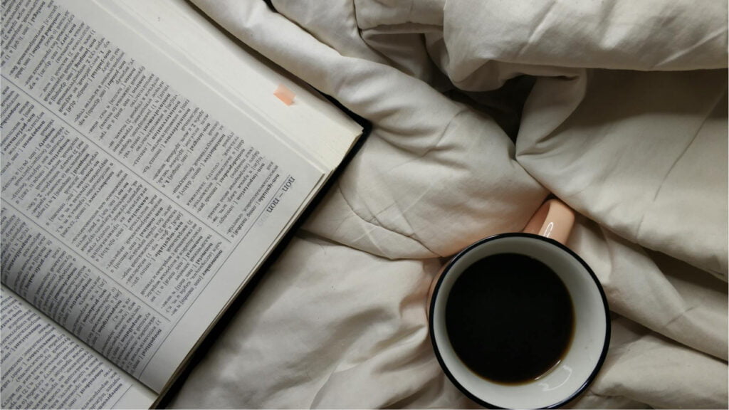 dictionary for affiliate marketing glossary on a bed with a cup of black coffee